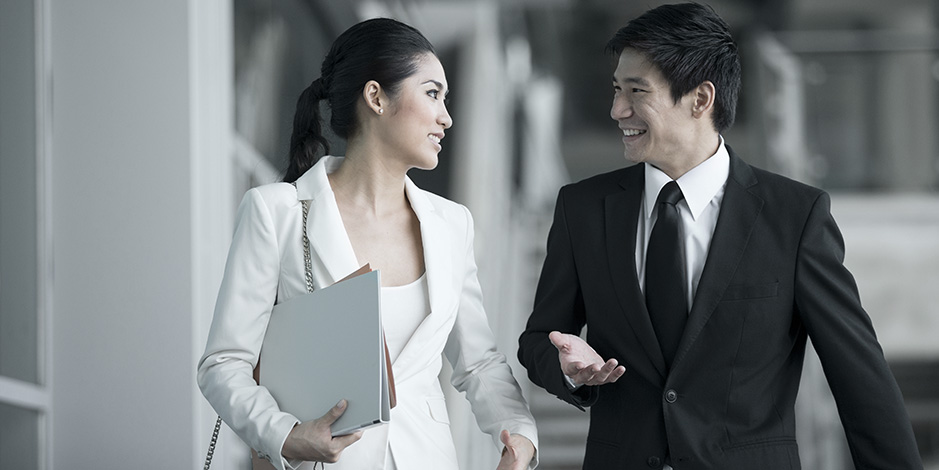 Asian business people talking outside