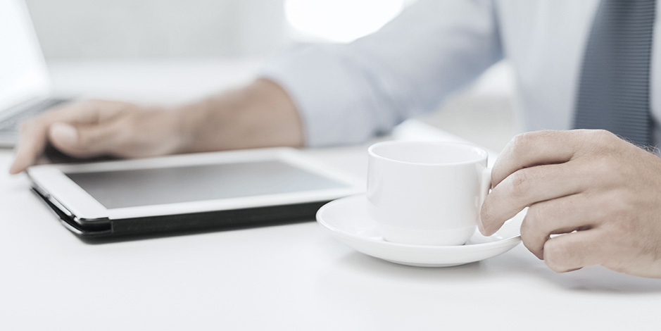 Businessman with coffee and tablet